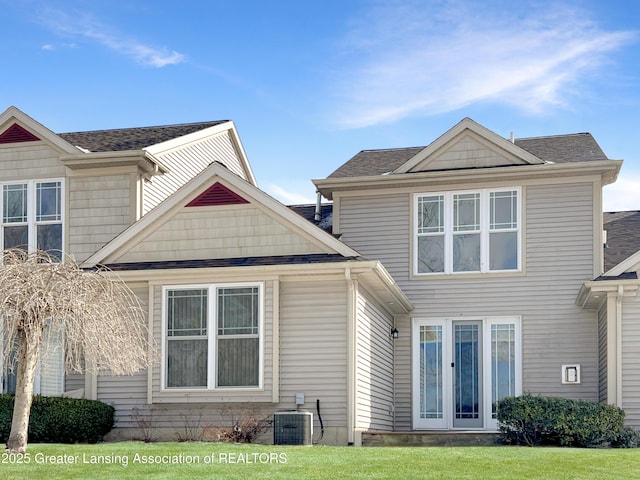 back of property featuring central air condition unit, french doors, and roof with shingles