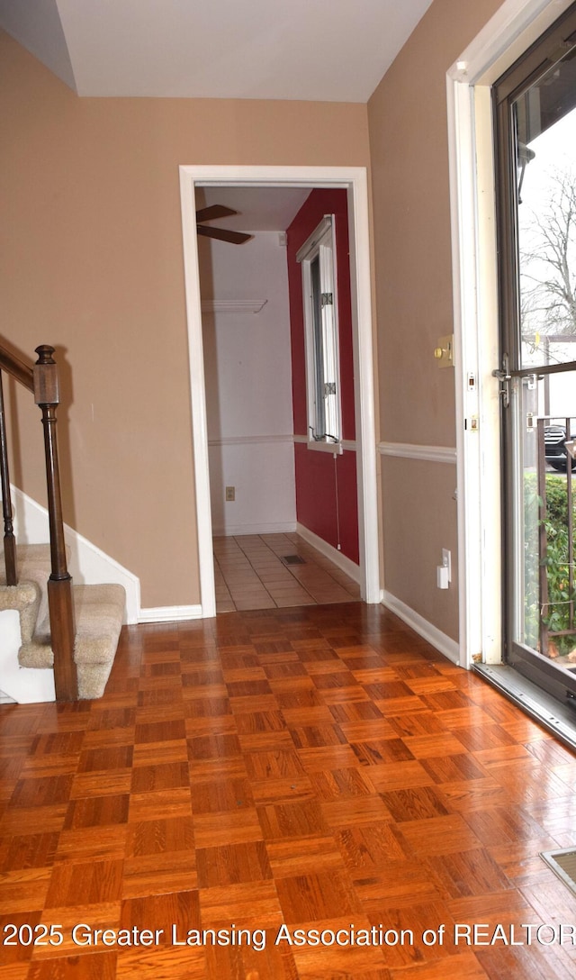 foyer entrance featuring parquet flooring