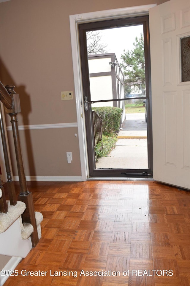 entrance foyer featuring parquet flooring