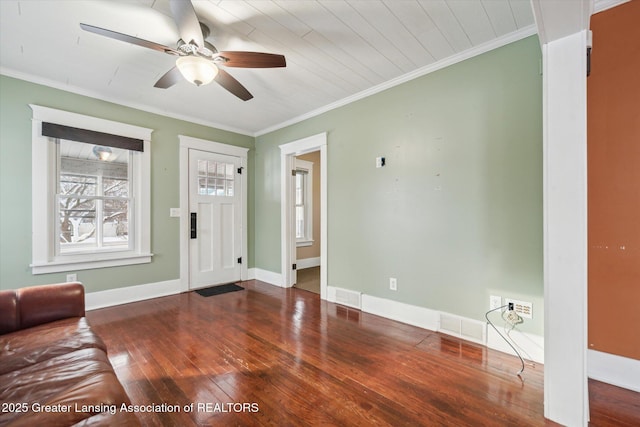 unfurnished living room featuring wood-type flooring, ornamental molding, and ceiling fan