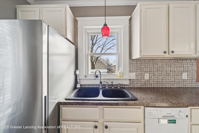 kitchen with stainless steel refrigerator, white cabinetry, sink, hanging light fixtures, and white dishwasher