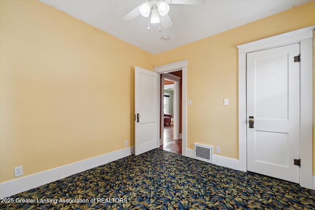 carpeted spare room featuring ceiling fan