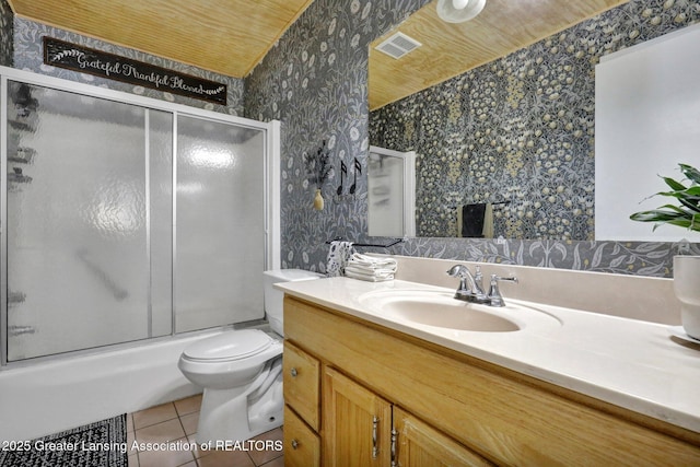 full bathroom featuring tile patterned flooring, vanity, shower / bath combination with glass door, and toilet