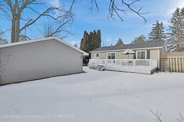 snow covered property featuring a deck