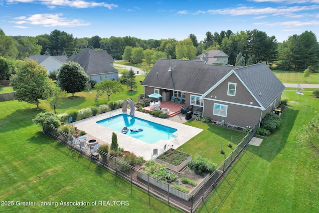 view of pool featuring a yard, a water slide, and a patio