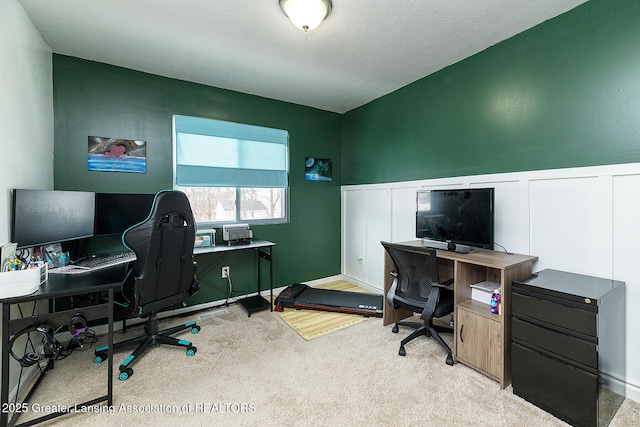 home office with light colored carpet and a textured ceiling