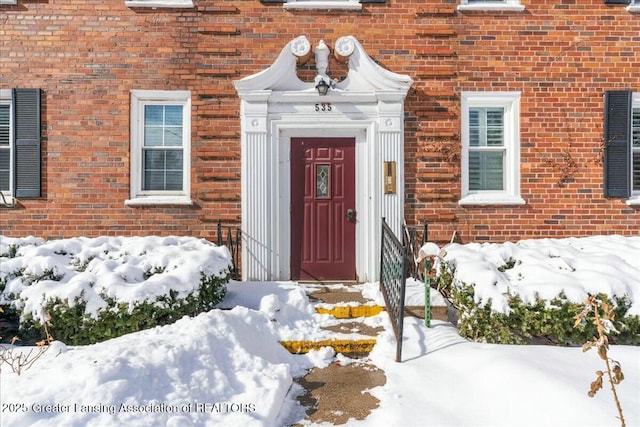 view of snow covered property entrance