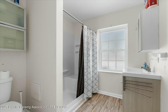 bathroom featuring a shower with curtain, vanity, hardwood / wood-style floors, and toilet