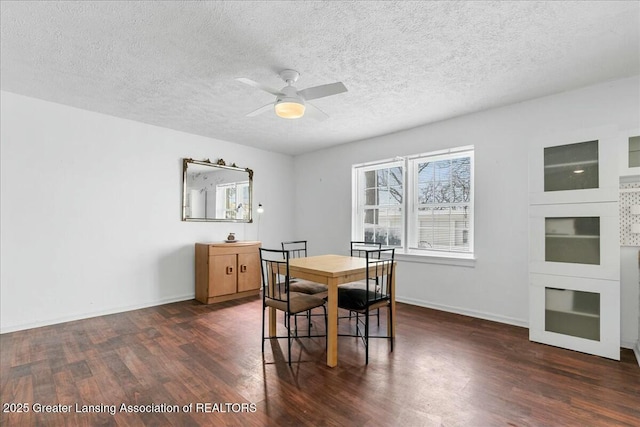 dining room featuring ceiling fan, dark hardwood / wood-style flooring, and a textured ceiling