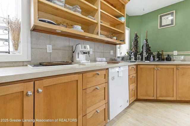 kitchen featuring light hardwood / wood-style flooring, tasteful backsplash, and dishwasher