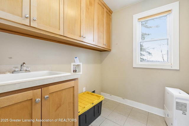 laundry room with washer hookup, cabinets, light tile patterned floors, and sink