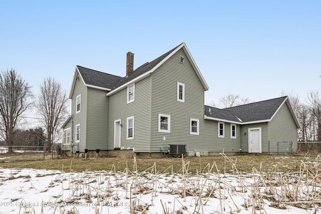 snow covered property featuring central air condition unit