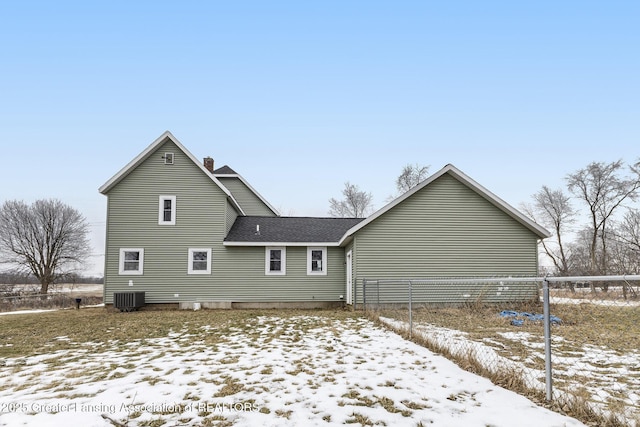 snow covered property featuring central air condition unit