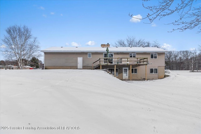 snow covered property featuring a deck