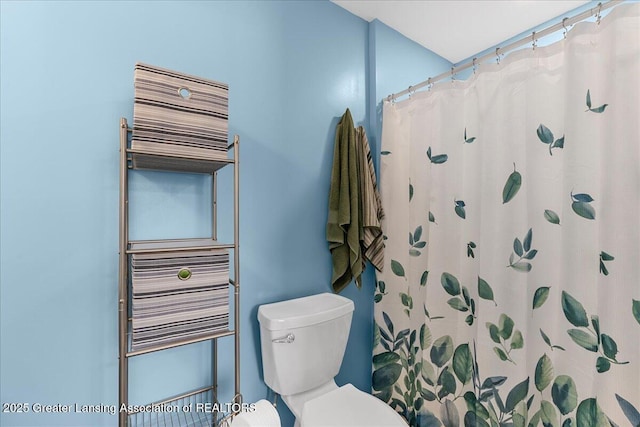 bathroom with walk in shower, radiator heating unit, and toilet