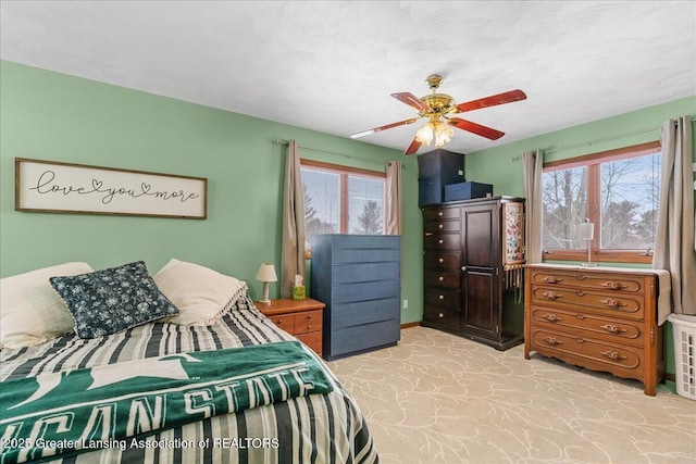 bedroom featuring light carpet and ceiling fan