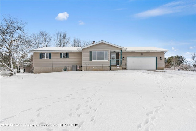 view of front of home featuring a garage and central AC unit