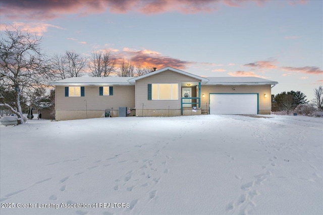 single story home featuring a garage and cooling unit