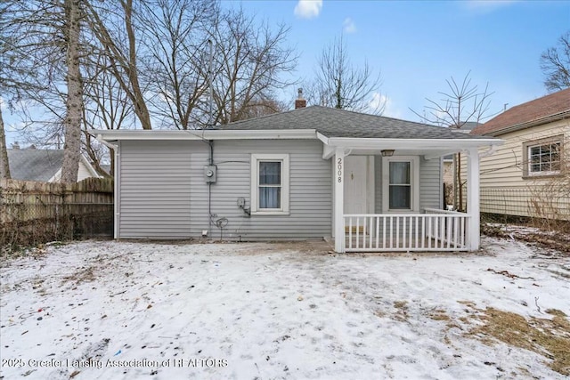 snow covered property featuring a porch