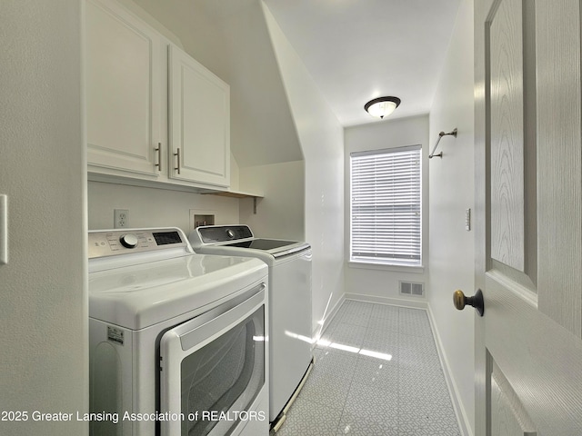 laundry area featuring cabinets, washing machine and dryer, and light tile patterned floors