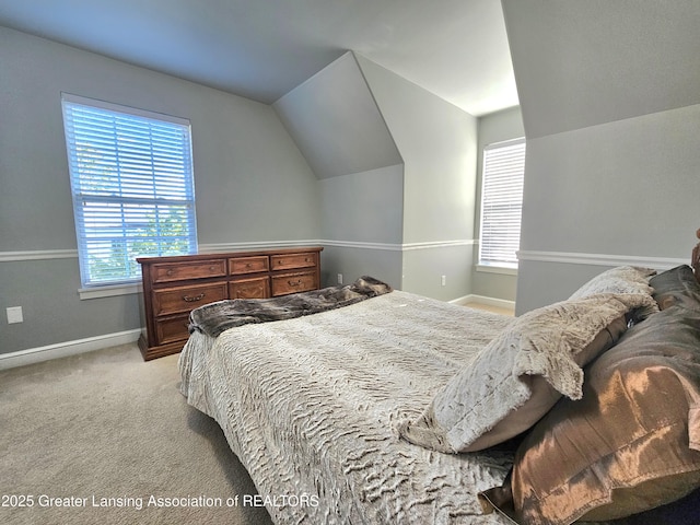 bedroom with vaulted ceiling and light colored carpet