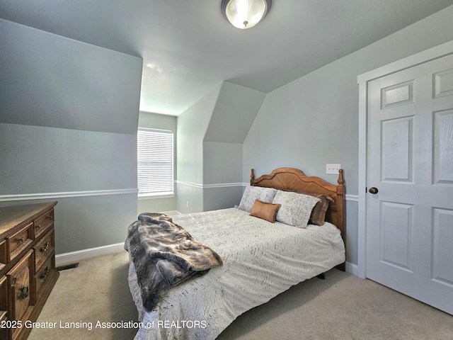 carpeted bedroom featuring vaulted ceiling