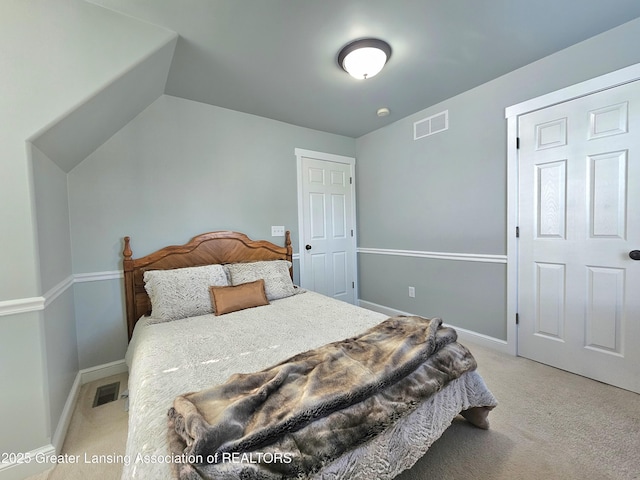 bedroom featuring lofted ceiling and light colored carpet