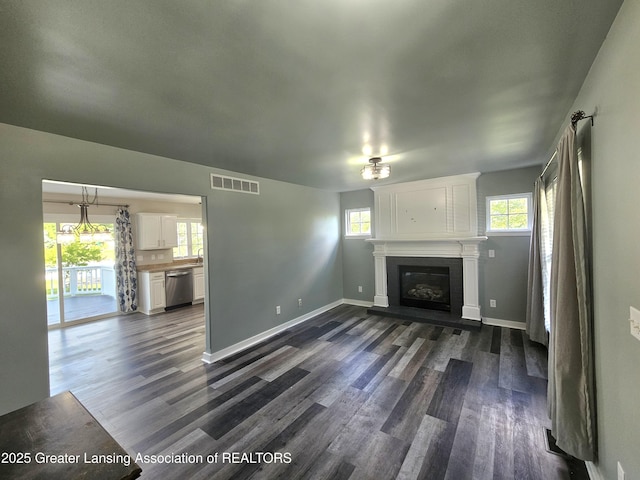 unfurnished living room with dark hardwood / wood-style floors