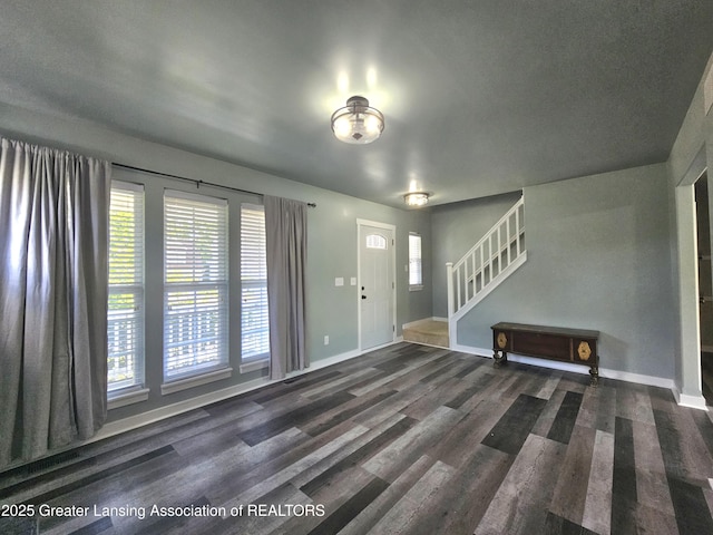 entrance foyer featuring dark wood-type flooring and a wealth of natural light