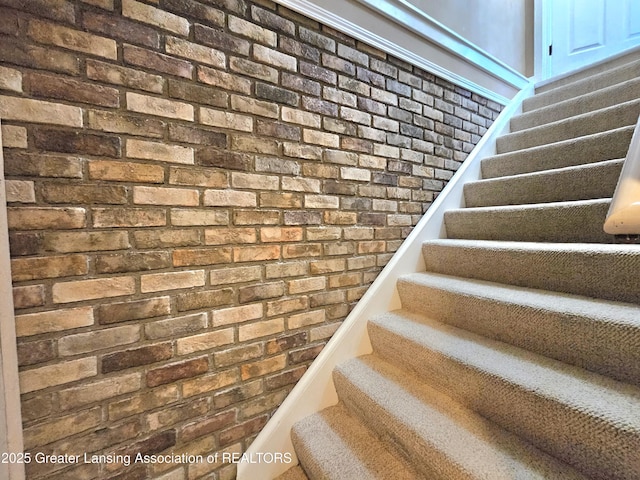 staircase with brick wall