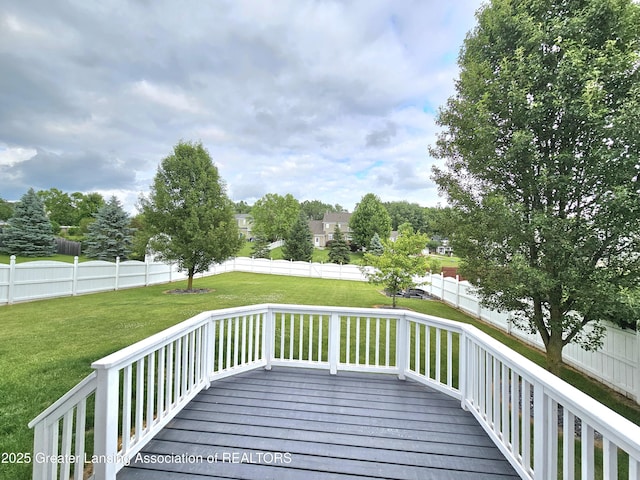 wooden deck featuring a yard