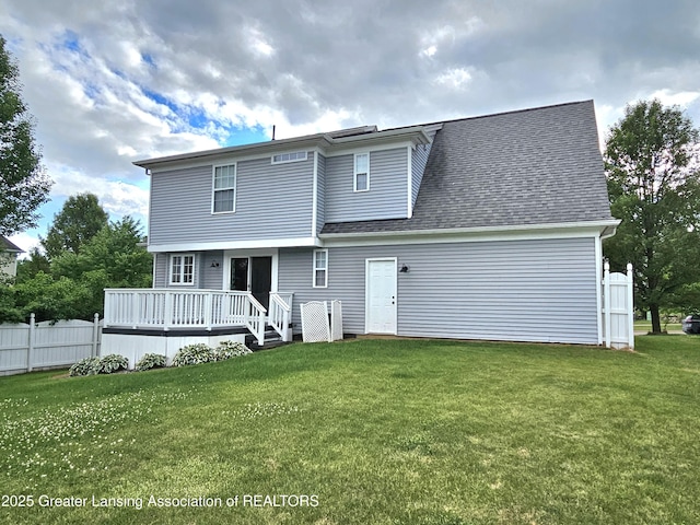 back of house with a wooden deck and a yard