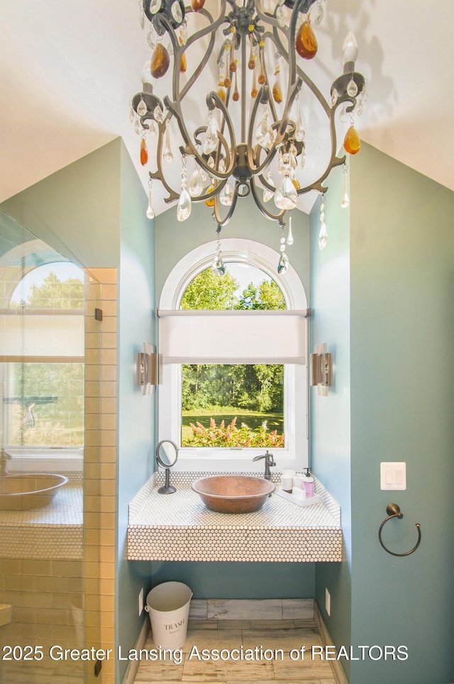 8955 W Braden Rd, Haslett, MI 48840 - bathroom with an inviting chandelier, sink, and a bath