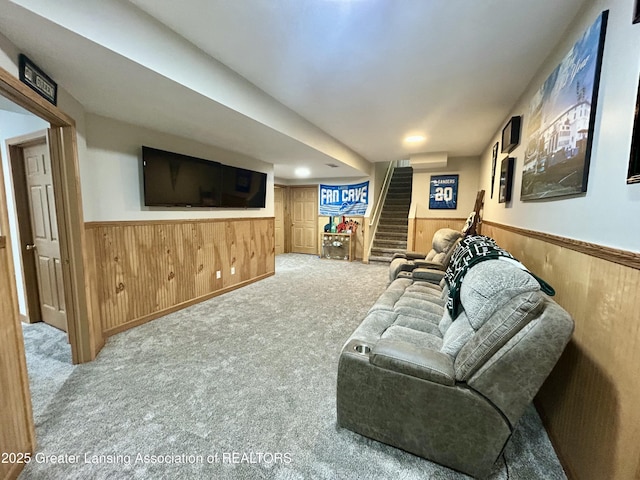 living room featuring light carpet and wood walls