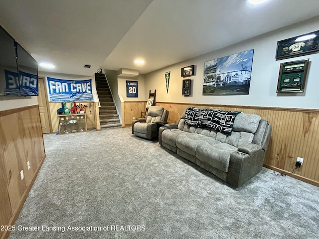 carpeted home theater featuring wood walls