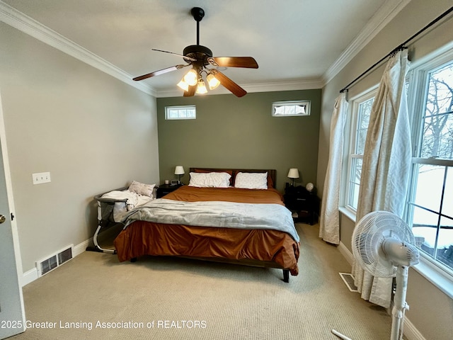 carpeted bedroom with crown molding and ceiling fan