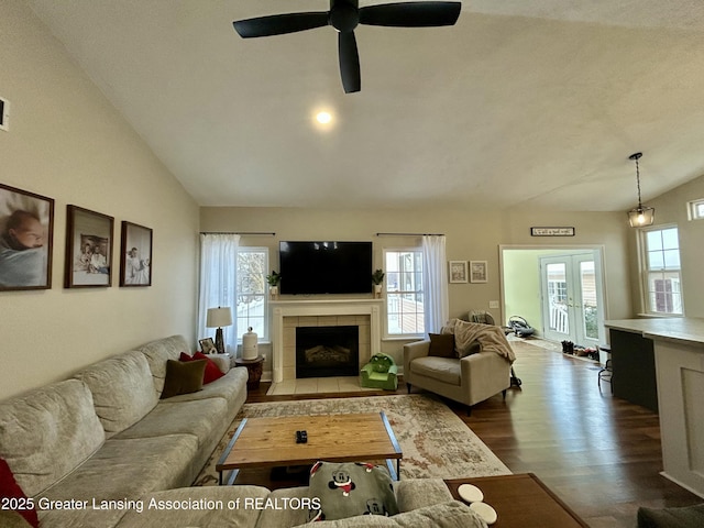 living room featuring french doors, a fireplace, lofted ceiling, and dark hardwood / wood-style flooring