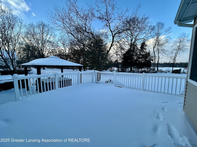 yard covered in snow with a gazebo and a deck