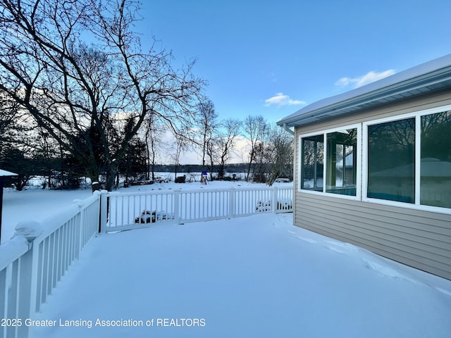 yard layered in snow with a wooden deck