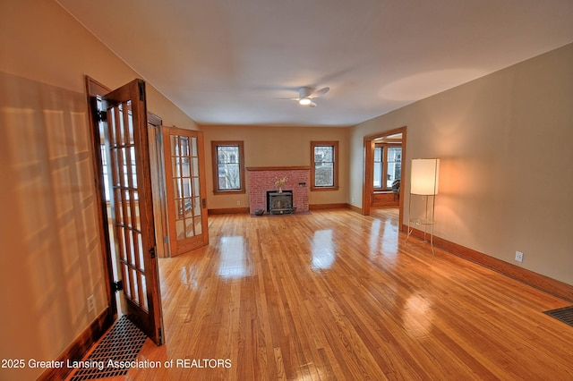 unfurnished living room with ceiling fan and light hardwood / wood-style floors