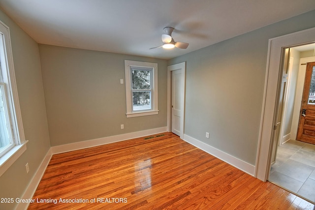 unfurnished room with light hardwood / wood-style flooring and ceiling fan