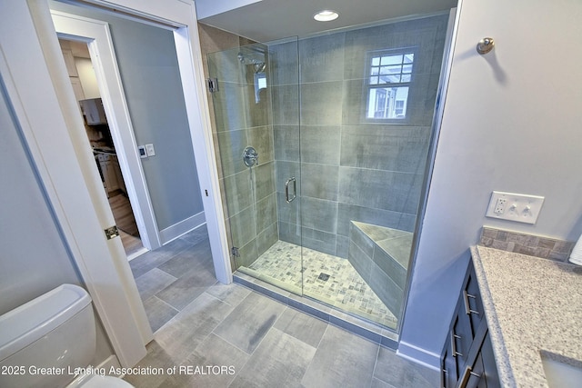 bathroom featuring vanity, an enclosed shower, and toilet