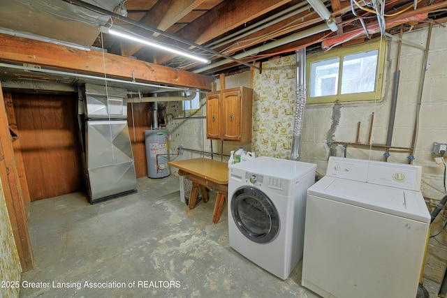 basement with heating unit, water heater, and washer and dryer