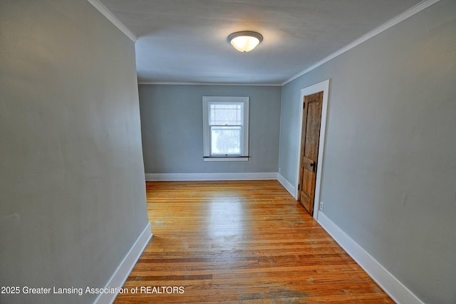 unfurnished room with light wood-type flooring and ornamental molding