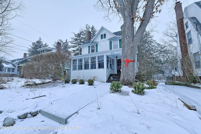 view of front of home featuring a sunroom