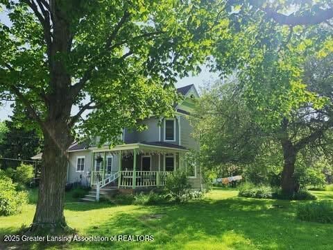 7761 W Herbison Rd, Dewitt, MI 48820 - view of front of property with a front lawn and covered porch