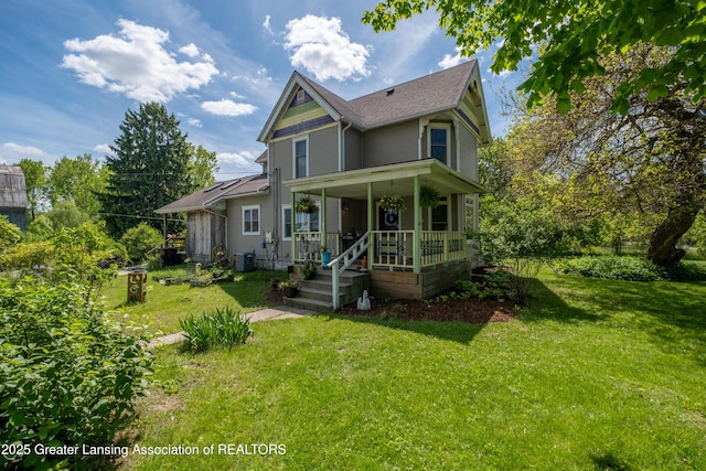 7761 W Herbison Rd, Dewitt, MI 48820 - victorian house with covered porch, a front lawn, and roof with shingles