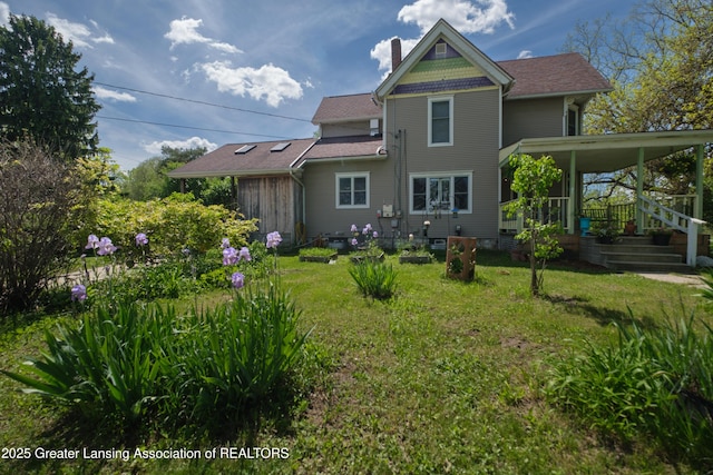 7761 W Herbison Rd, Dewitt, MI 48820 - back of house featuring a chimney, a lawn, covered porch, and a shingled roof