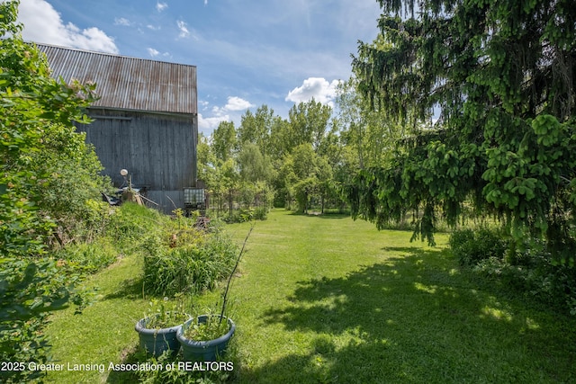 7761 W Herbison Rd, Dewitt, MI 48820 - view of grassy yard with an outbuilding