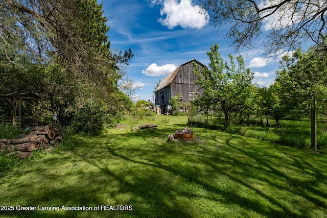 7761 W Herbison Rd, Dewitt, MI 48820 - view of green lawn featuring a barn and an outdoor structure